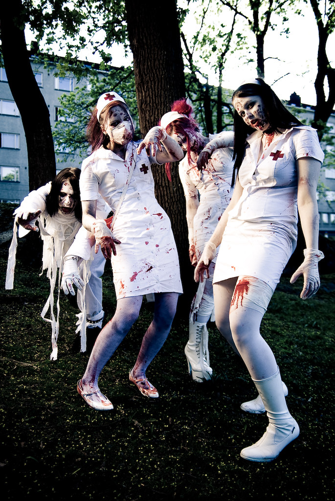 Bloodstained ghouls in nurses uniforms stumble towards camera
